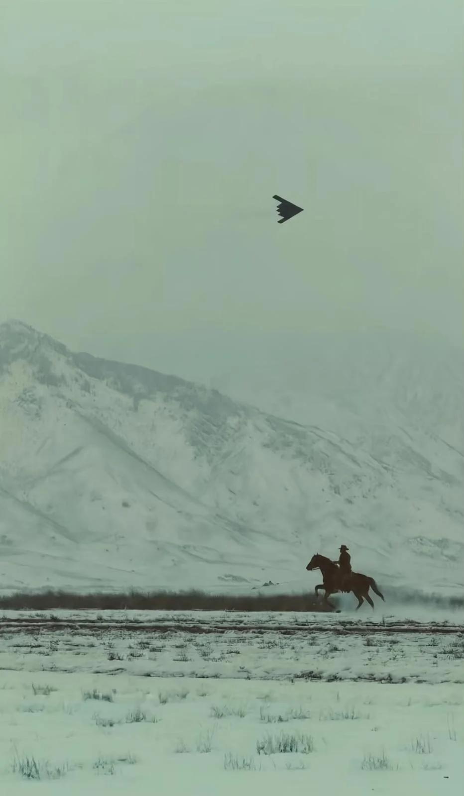A horse rider gallops across a snowy plain as a jet flies overhead